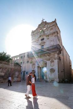 couple men and woman on citytrip, Ortigia in Syracuse Sicily Italy in the Morning. Travel Photography from Syracuse, Italy on the island of Sicily. 