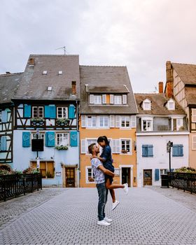 couple on city trip Colmar, Alsace, France. Petite Venice, water canal and traditional half timbered houses. Colmar is a charming town in Alsace, France. Beautiful view of colorful romantic city Colmar