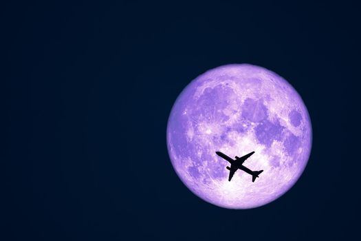 Full Crow Moon and silhouette airplane flight on night sky, Elements of this image furnished by NASA