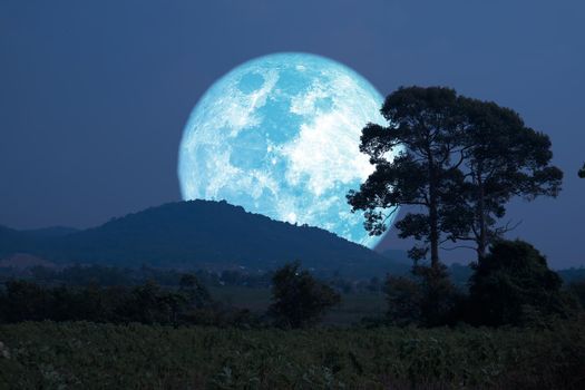 Super harvest blue moon silhouette mountain and  the field on night sky, Elements of this image furnished by NASA