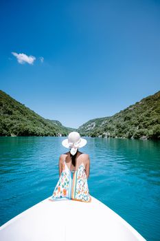 young girl view to the cliffy rocks of Verdon Gorge at lake of Sainte Croix, Provence, France, near Moustiers SainteMarie, department Alpes de Haute Provence, region Provence Alpes Cote Azur. France