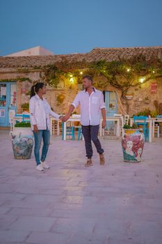 The picturesque village of Marzamemi, in the province of Syracuse, Sicily Italy, a couple on vacation in Sicilia