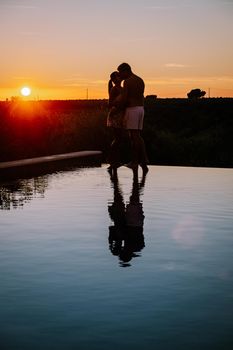 Luxury resort with a view over the wine field in Selinunte Sicily Italy. infinity pool with a view over wine fields in Sicilia, a couple on luxury vacation at the Island of Sicily Italy