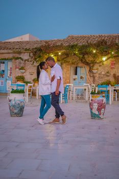 The picturesque village of Marzamemi, in the province of Syracuse, Sicily Italy, a couple on vacation in Sicilia