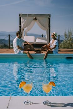 Luxury country house with swimming pool in Italy. Pool and old farm house during sunset central Italy. Couple on Vacation at luxury villa in Italy, men and woman watching sunset