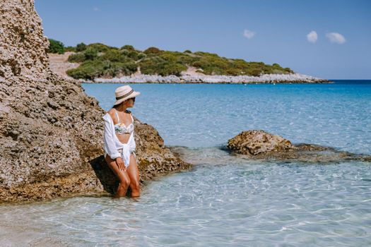 Tropical beach of Voulisma beach, Istron, Crete, Greece ,Most beautiful beaches of Crete island -Istron bay near Agios Nikolaos young asian woman mid age on vacation Greece Crete