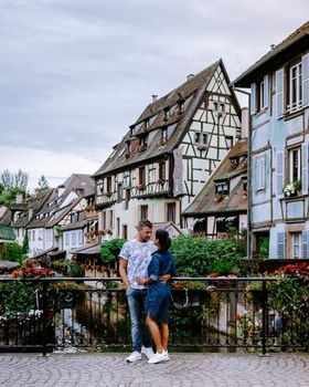 couple on city trip Colmar, Alsace, France. Petite Venice, water canal and traditional half timbered houses. Colmar is a charming town in Alsace, France. Beautiful view of colorful romantic city Colmar