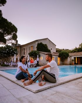 couple relaxing by the pool in the Provence France, men and woman relaxing by pool at luxury resort France