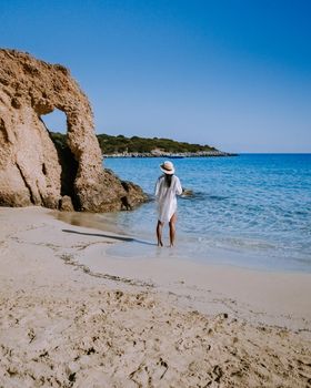 Tropical beach of Voulisma beach, Istron, Crete, Greece ,Most beautiful beaches of Crete island -Istron bay near Agios Nikolaos young asian woman mid age on vacation Greece Crete