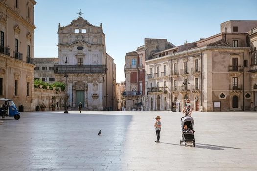 Ortigia in Syracuse Sicily Italy October 2020 in the Morning. Travel Photography from Syracuse, Italy on the island of Sicily. Cathedral Plaza and market with people wearing face protection during the 2020 pandemic covid 19 corona virus