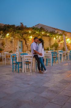 The picturesque village of Marzamemi, in the province of Syracuse, Sicily Italy, a couple on vacation in Sicilia