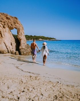 Tropical beach of Voulisma beach, Istron, Crete, Greece ,Most beautiful beaches of Crete island -Istron bay near Agios Nikolaos young couple mid age on vacation in Greece Crete