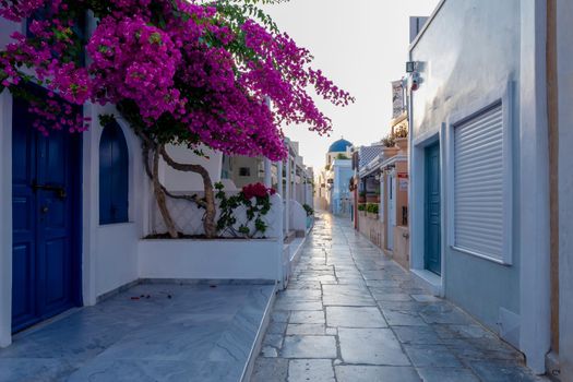 Sunset at the Island Of Santorini Greece, beautiful whitewashed village Oia with church and windmill during sunset, streets of Oia Santorini during summer vacation at the Greek Island