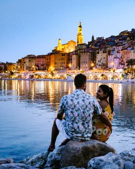 couple men and woman on vacation at the town of Menton in the Provence France during summer in Europe