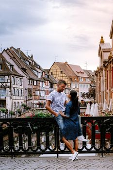 couple on city trip Colmar, Alsace, France. Petite Venice, water canal and traditional half timbered houses. Colmar is a charming town in Alsace, France. Beautiful view of colorful romantic city Colmar