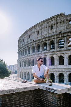 View of Colosseum in Rome and morning sun, Italy, Europe. young guy on city trip Rome