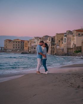 Cefalu, the medieval village of Sicily island, Province of Palermo, Italy. Europe, a couple on vacation at the Italian Island Sicilia