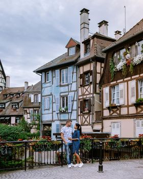 couple on city trip Colmar, Alsace, France. Petite Venice, water canal and traditional half timbered houses. Colmar is a charming town in Alsace, France. Beautiful view of colorful romantic city Colmar