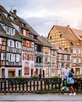 couple on city trip Colmar, Alsace, France. Petite Venice, water canal and traditional half timbered houses. Colmar is a charming town in Alsace, France. Beautiful view of colorful romantic city Colmar