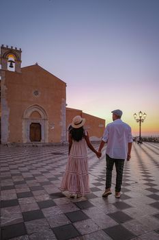 Taormina Sicily, Belvedere of Taormina and San Giuseppe church on the square Piazza IX Aprile in Taormina. Sicily, Italy. Couple on vacation at the Italian Island Sicily