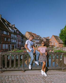 couple on city trip Colmar, Alsace, France. Petite Venice, water canal and traditional half timbered houses. Colmar is a charming town in Alsace, France. Beautiful view of colorful romantic city Colmar