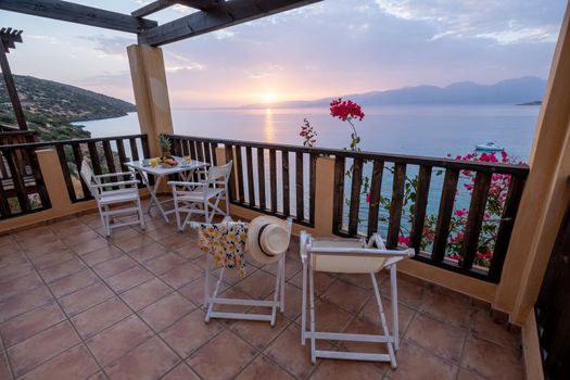 table and chairs with breakfast during sunrise at the meditarian sea in Greece. High quality photo