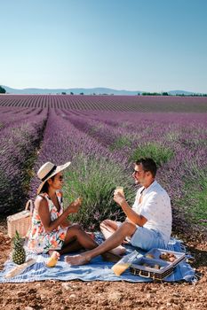 couple mid age men and woman on vacation in the Provence visiting the blooming lavender fields in France. Europe