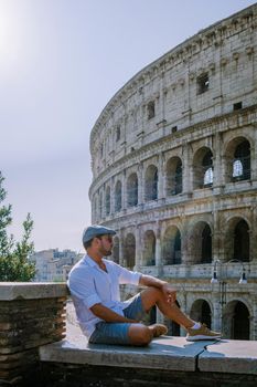 View of Colosseum in Rome and morning sun, Italy, Europe. young guy on city trip Rome