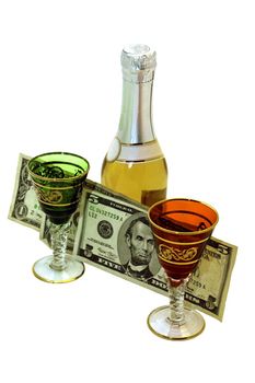 between the colorful shot glasses and a bottle of wine dollars in small bills