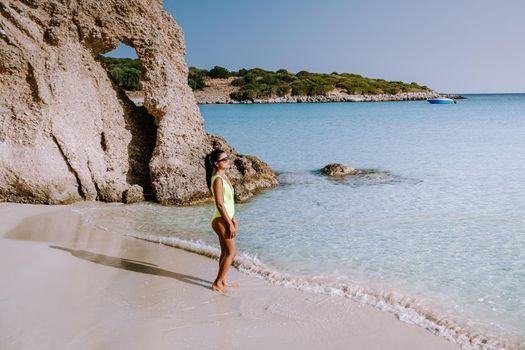 Tropical beach of Voulisma beach, Istron, Crete, Greece ,Most beautiful beaches of Crete island -Istron bay near Agios Nikolaos. young woman on the beach of Crete