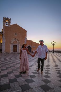 Taormina Sicily, Belvedere of Taormina and San Giuseppe church on the square Piazza IX Aprile in Taormina. Sicily, Italy. Couple on vacation at the Italian Island Sicily