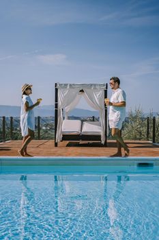 Luxury country house with swimming pool in Italy. Pool and old farm house during sunset central Italy. Couple on Vacation at luxury villa in Italy, men and woman watching sunset