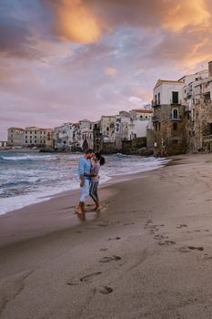 Cefalu, the medieval village of Sicily island, Province of Palermo, Italy. Europe, a couple on vacation at the Italian Island Sicilia