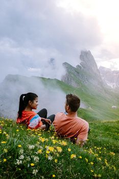 couple on vacation hiking in the Italien Dolomites, Amazing view on Seceda peak. Trentino Alto Adige, Dolomites Alps, South Tyrol, Italy, Europe.