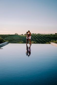 Luxury resort with a view over the wine field in Selinunte Sicily Italy. infinity pool with a view over wine fields in Sicilia, a couple on luxury vacation at the Island of Sicily Italy