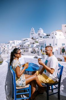 Pyrgos, Santorini, Greece. Famous attraction of white village with cobbled streets, Greek Cyclades Islands, Aegean Sea couple on vacation Santorini Greece Europe