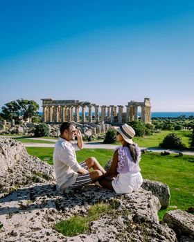 A couple visit Greek temples at Selinunte during vacation, View on sea and ruins of greek columns in Selinunte Archaeological Park Sicily Italy