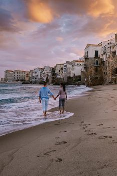 Cefalu, the medieval village of Sicily island, Province of Palermo, Italy. Europe, a couple on vacation at the Italian Island Sicilia