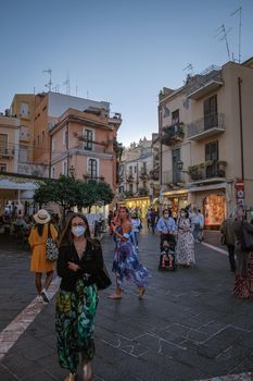 Taormina Sicily Italy October 2020, people on the streets using face mask during the pandemic Corona Covid 19 virus outbreak. 