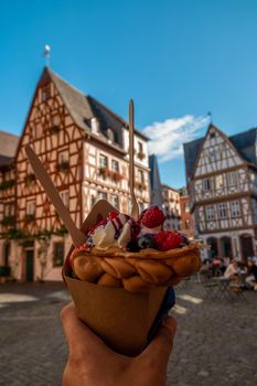 Mainz Germany hand with ice cream, Classical timber houses in the center of Mainz, Germany Europe
