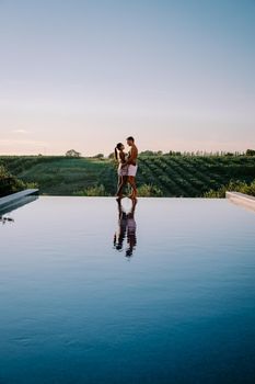 Luxury resort with a view over the wine field in Selinunte Sicily Italy. infinity pool with a view over wine fields in Sicilia, a couple on luxury vacation at the Island of Sicily Italy