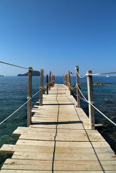 Close up wooden bridge leading to horizon, sea ocean. Pathway to future, adventure world, goal reaching, beginning, discover concept.