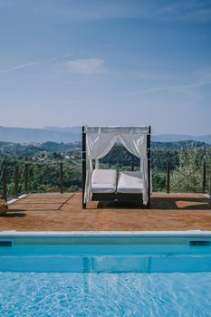 Luxury country house with swimming pool in Italy. Pool and old farm house during sunset central Italy. Couple on Vacation at luxury villa in Italy, men and woman watching sunset