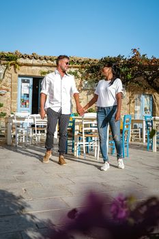 The picturesque village of Marzamemi, in the province of Syracuse, Sicily Italy, a couple on vacation in Sicilia