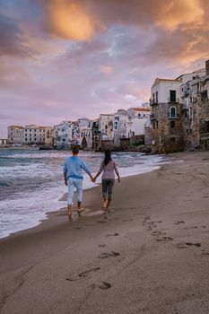 Cefalu, the medieval village of Sicily island, Province of Palermo, Italy. Europe, a couple on vacation at the Italian Island Sicilia