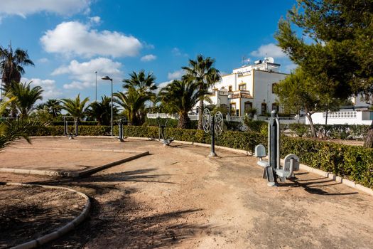 exercise equipment for public use, outdoors in spanish park area