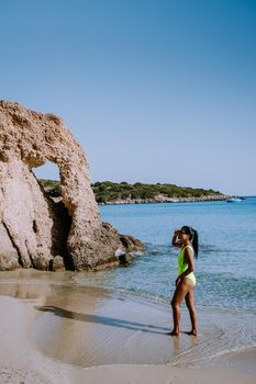 Tropical beach of Voulisma beach, Istron, Crete, Greece ,Most beautiful beaches of Crete island -Istron bay near Agios Nikolaos. young woman on the beach of Crete