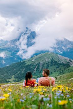 couple on vacation hiking in the Italien Dolomites, Amazing view on Seceda peak. Dolomites Alps, South Tyrol, Italy, Europe