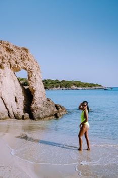 Tropical beach of Voulisma beach, Istron, Crete, Greece ,Most beautiful beaches of Crete island -Istron bay near Agios Nikolaos. young woman on the beach of Crete