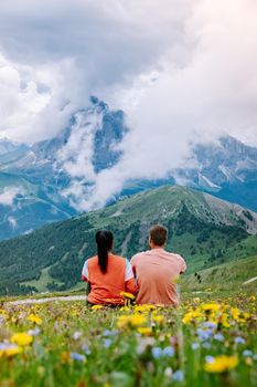 couple on vacation hiking in the Italien Dolomites, Amazing view on Seceda peak. Dolomites Alps, South Tyrol, Italy, Europe